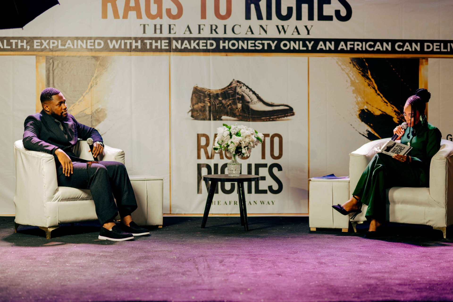 M.N. Onyeachor in conversation on stage at the Rags to Riches book launch