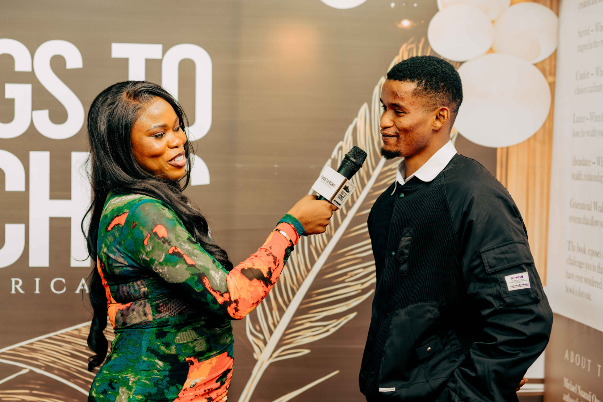 A guest being interviewed on the red carpet at the book launch